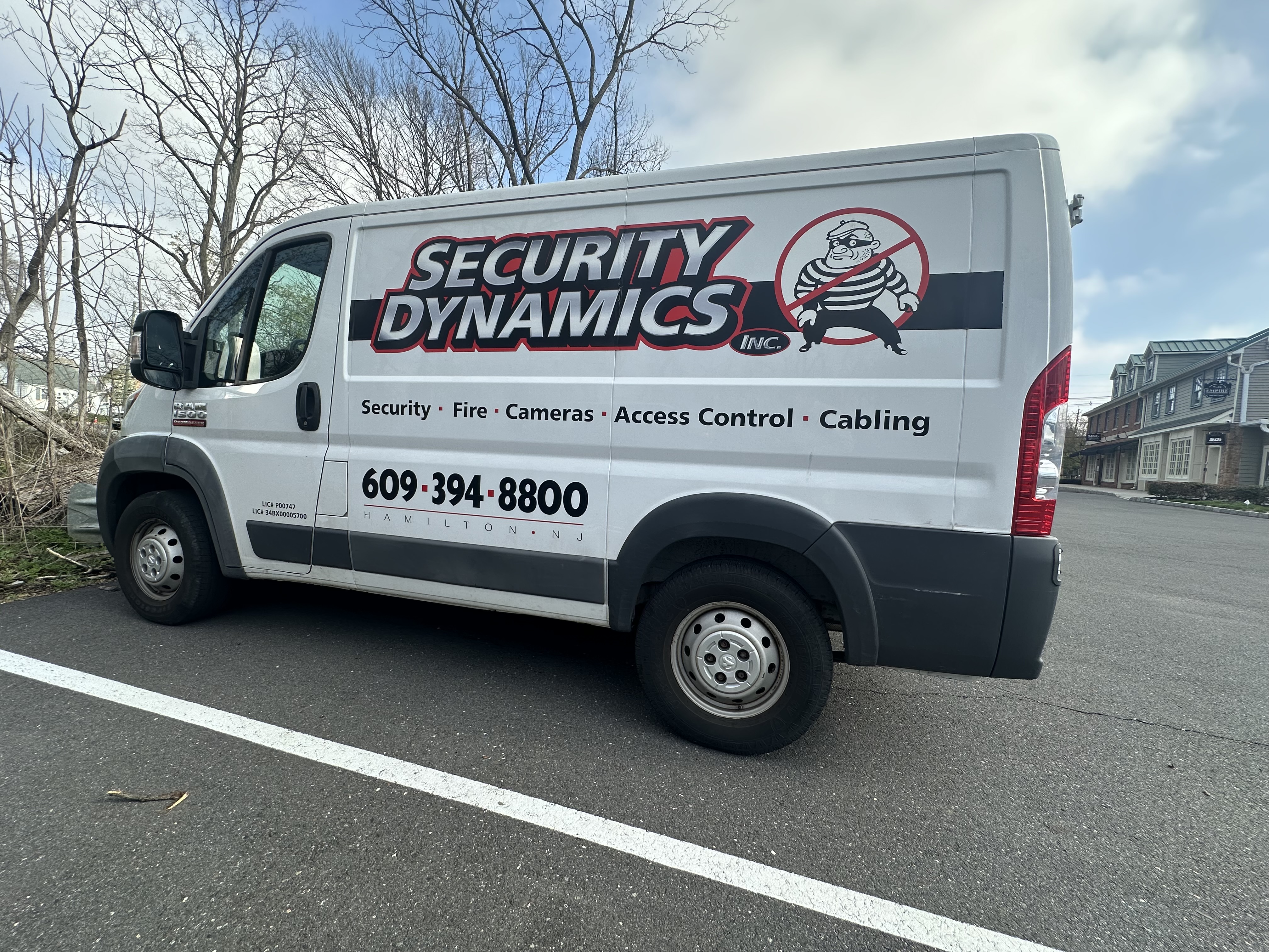 Security Dynamics branded service van — side view with phone number and services listed