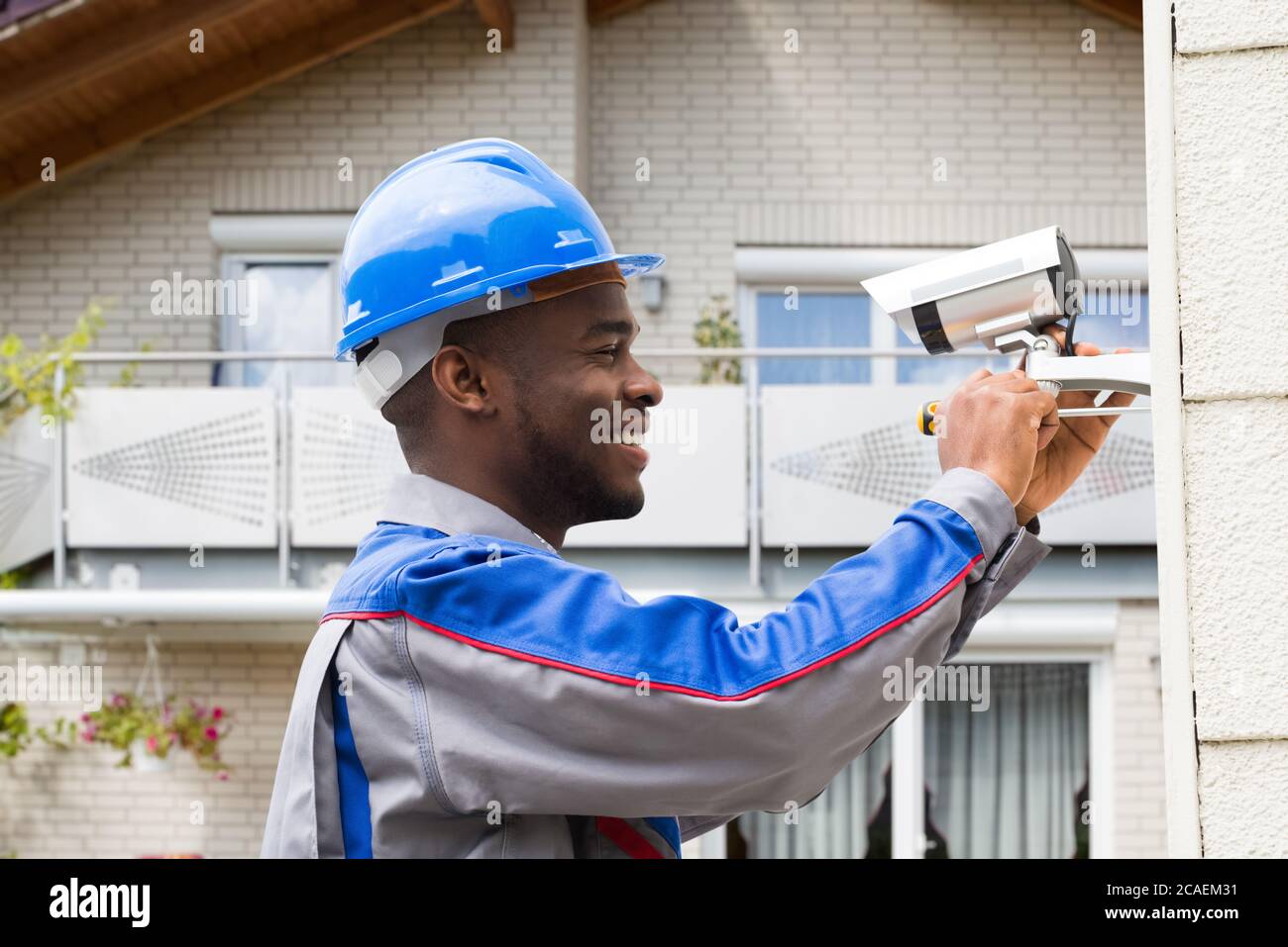 Security technician installing camera system