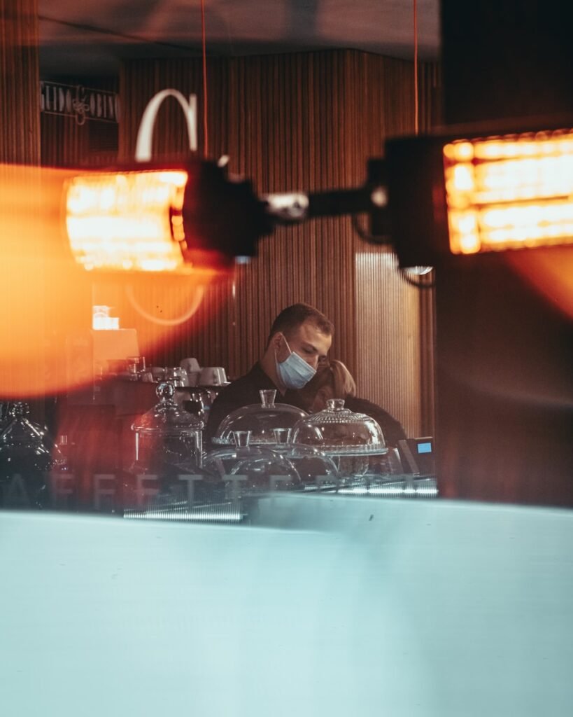 a man in a mask working on a machine